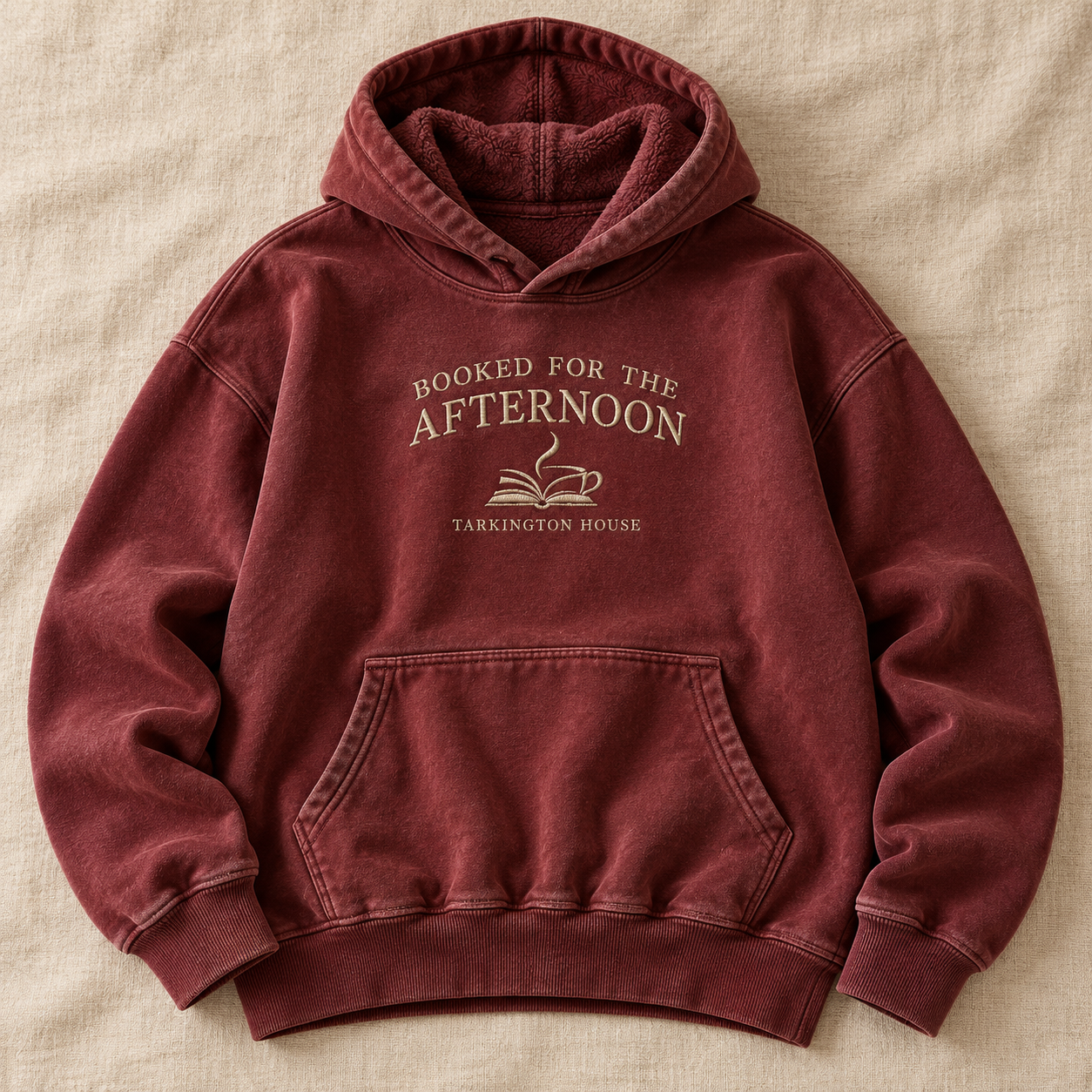 Design concept for a cozy washed-oxblood Booked for the Afternoon hoodie with ivory embroidered lettering